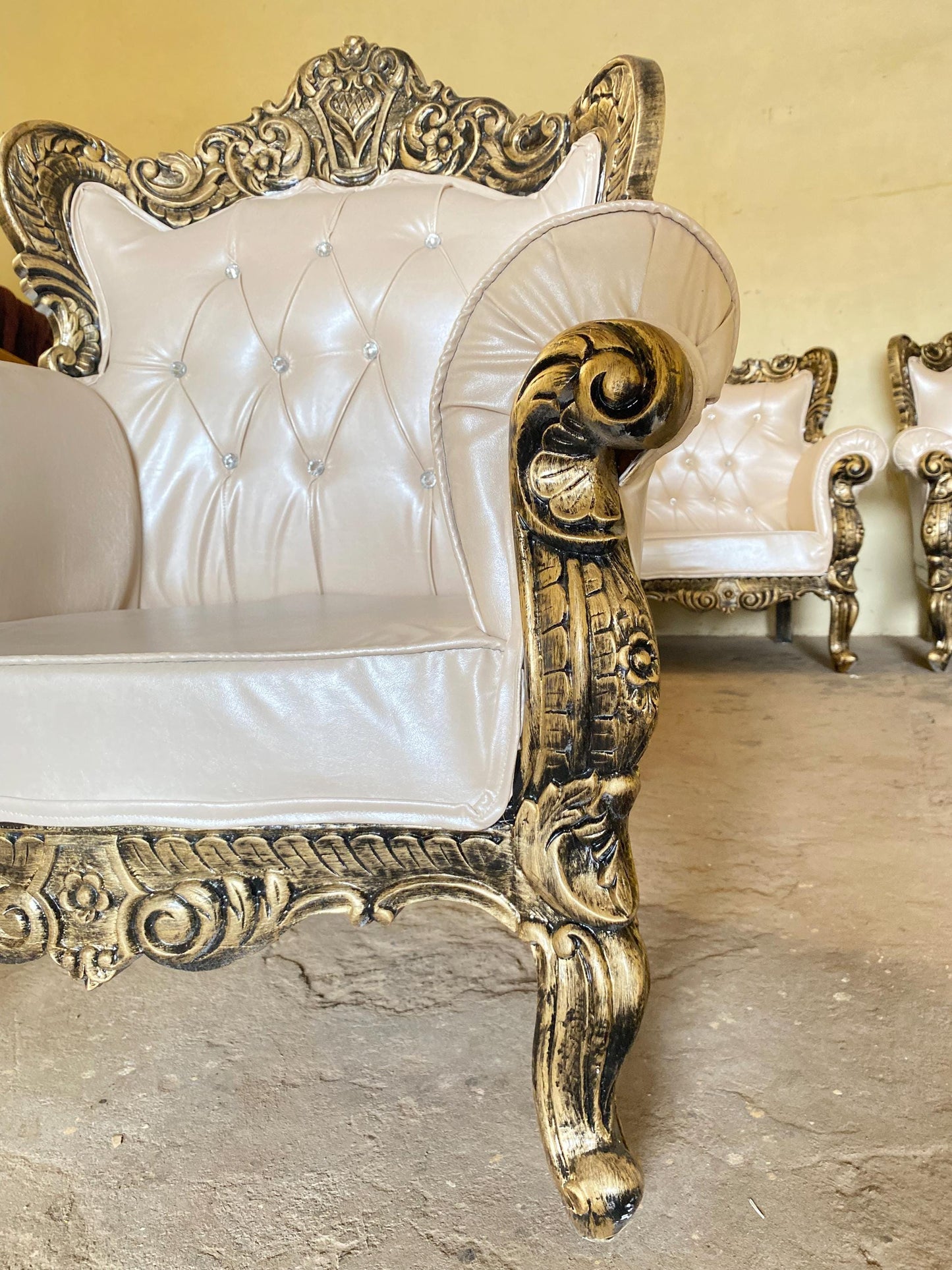 Hand Carved Louis XVI Sofa: Rustic Gold Teak, Cream Upholstery